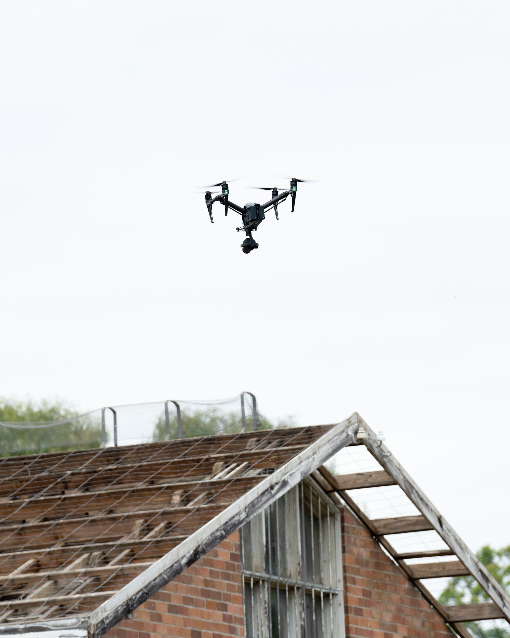 Aerial drone flying over a weathered rooftop in Sydney, capturing unique architectural views.